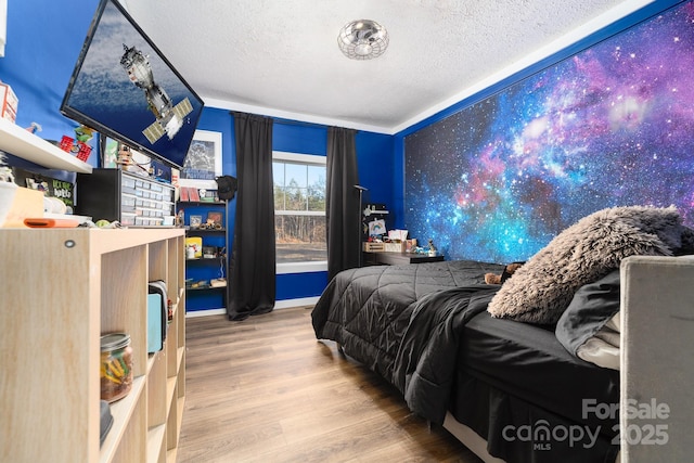 bedroom with a textured ceiling and hardwood / wood-style floors