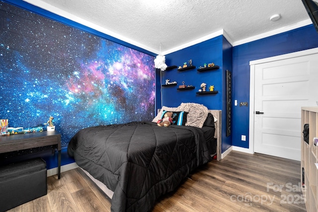 bedroom featuring a textured ceiling and hardwood / wood-style floors