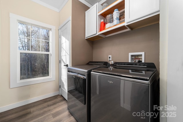 laundry room with cabinets, hardwood / wood-style floors, washing machine and dryer, and crown molding