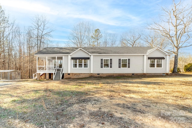 view of front facade featuring a front yard, a porch, and a carport