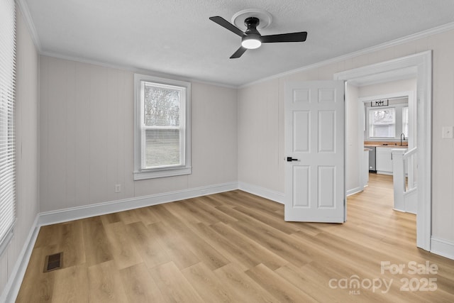 unfurnished bedroom featuring ceiling fan, ornamental molding, and sink