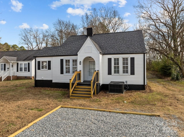 view of front of house featuring a front lawn and central AC unit