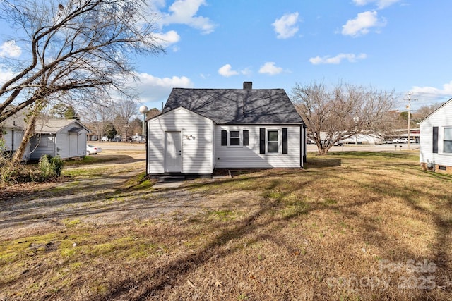 rear view of property with a yard