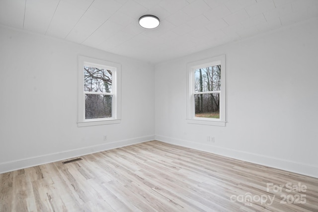 spare room with light wood-type flooring