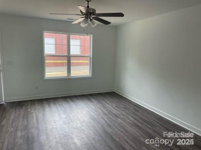 empty room featuring dark hardwood / wood-style flooring and ceiling fan