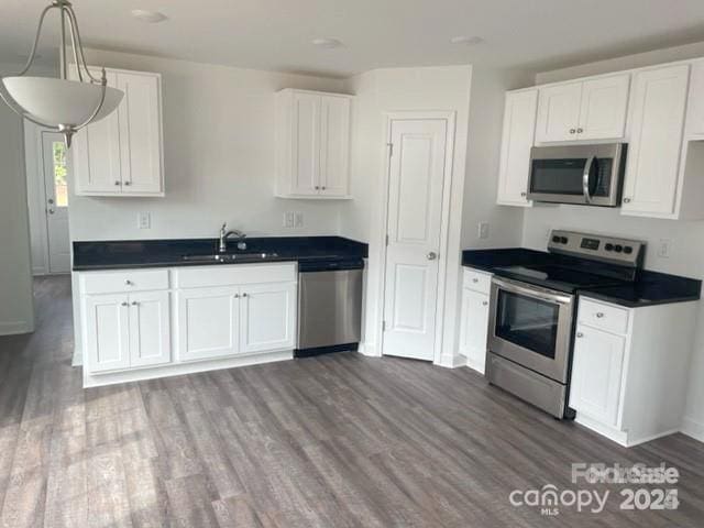 kitchen with sink, white cabinetry, and appliances with stainless steel finishes