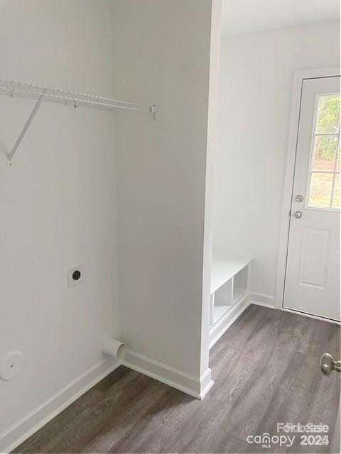 laundry area with dark wood-type flooring and electric dryer hookup