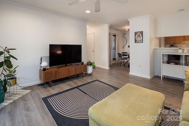 living room featuring crown molding, dark hardwood / wood-style floors, and ceiling fan