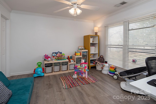 recreation room featuring crown molding, hardwood / wood-style floors, and ceiling fan