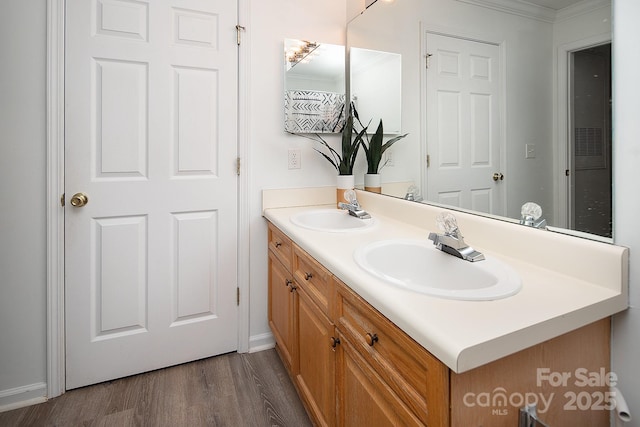 bathroom featuring vanity, crown molding, and wood-type flooring