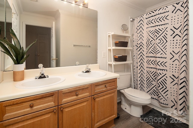 bathroom featuring crown molding, hardwood / wood-style floors, vanity, and toilet