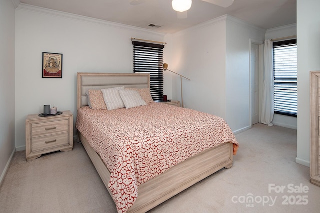 bedroom with crown molding, ceiling fan, and light carpet