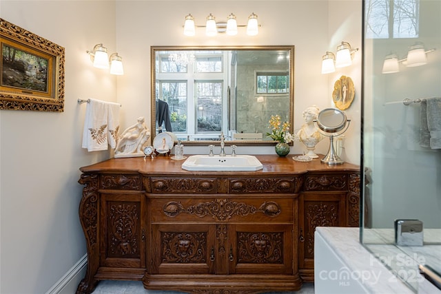 bathroom featuring baseboard heating and vanity