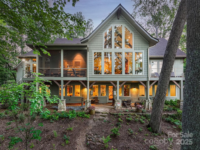 47 Twilight Sedge Dr, Biltmore Lake, NC 28715 - back of house featuring a sunroom, a shingled roof, and a patio