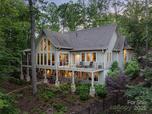 47 Twilight Sedge Dr, Biltmore Lake, NC 28715 - back of house with a patio area, roof with shingles, a sunroom, and view of wooded area