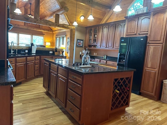 kitchen with wooden ceiling, black appliances, hanging light fixtures, beamed ceiling, and a kitchen island