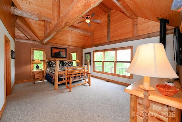 bedroom with beam ceiling, light colored carpet, multiple windows, and wood ceiling