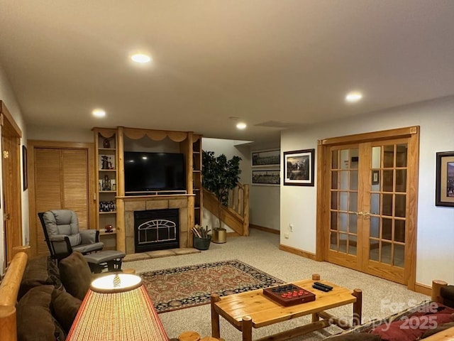 carpeted living room with a fireplace and french doors