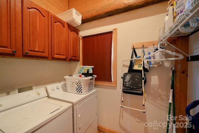 washroom with cabinets and washer and clothes dryer