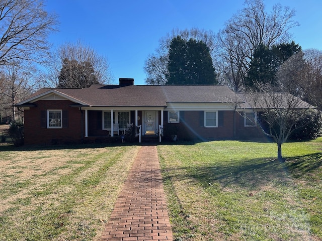 ranch-style home with a porch and a front lawn