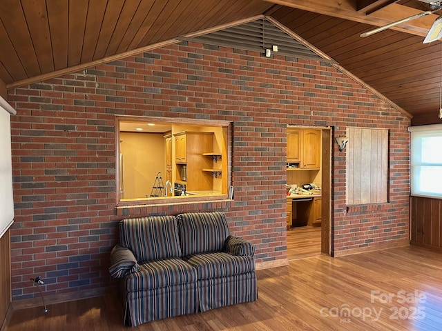 living area featuring wooden ceiling and brick wall