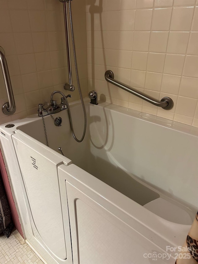 bathroom featuring tile patterned flooring and a washtub