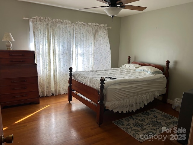 bedroom with wood-type flooring and ceiling fan