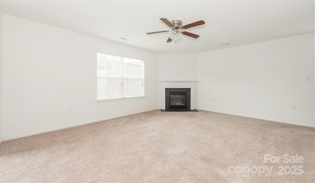 unfurnished living room with light colored carpet and ceiling fan