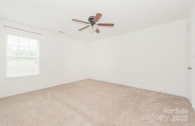 unfurnished room with ceiling fan and light colored carpet