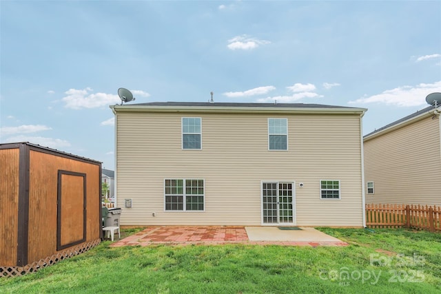 back of house with a patio and a lawn