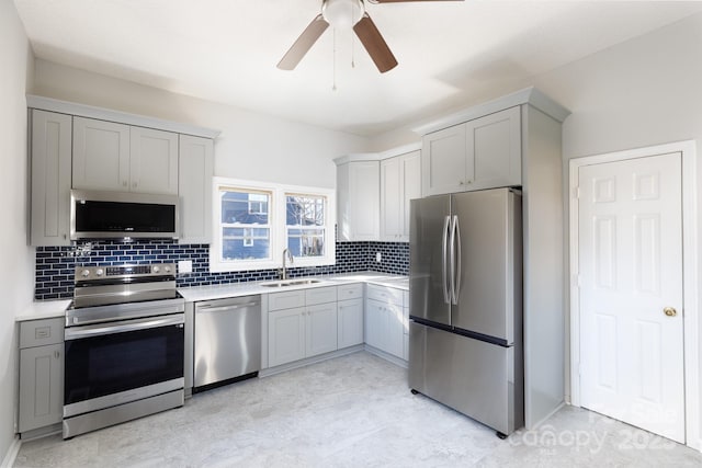 kitchen with ceiling fan, gray cabinets, sink, and appliances with stainless steel finishes