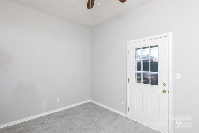 spare room with a textured ceiling and ceiling fan