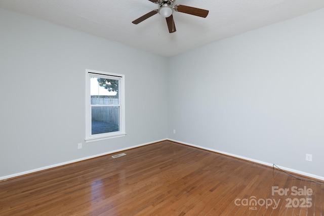 unfurnished room with ceiling fan and wood-type flooring