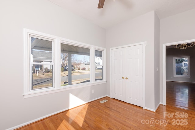 unfurnished bedroom featuring a closet, ceiling fan, and hardwood / wood-style flooring