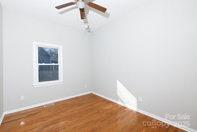 unfurnished room featuring ceiling fan and hardwood / wood-style flooring