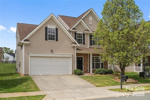 view of front of home featuring a front yard and a garage