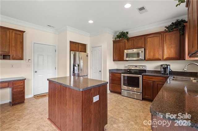 kitchen with dark stone countertops, stainless steel appliances, a center island, crown molding, and sink