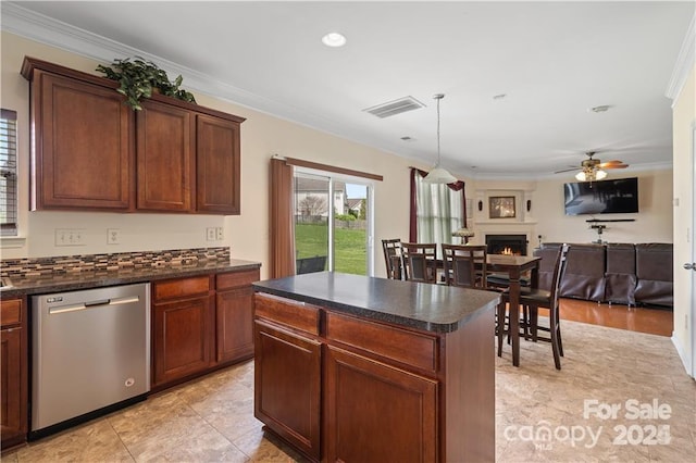 kitchen with dishwasher, ornamental molding, ceiling fan, a kitchen island, and decorative light fixtures