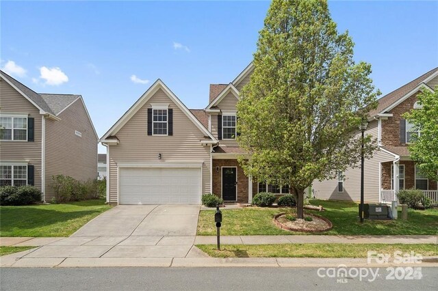 6107 Follow The Trl, Indian Trail, NC 28079 - view of front facade with driveway, a front lawn, an attached garage, and brick siding