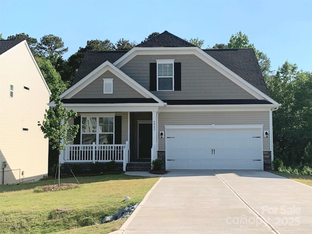 craftsman-style home featuring a front yard, a garage, and a porch