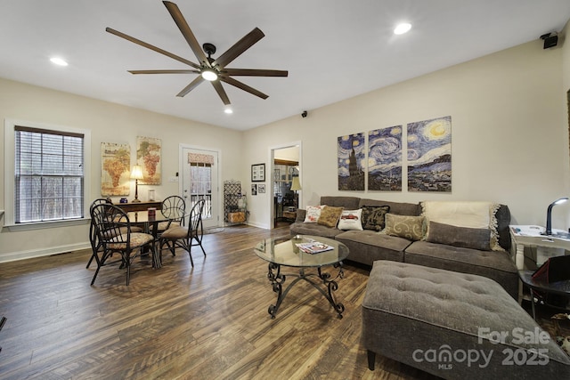 living room with dark hardwood / wood-style flooring and ceiling fan