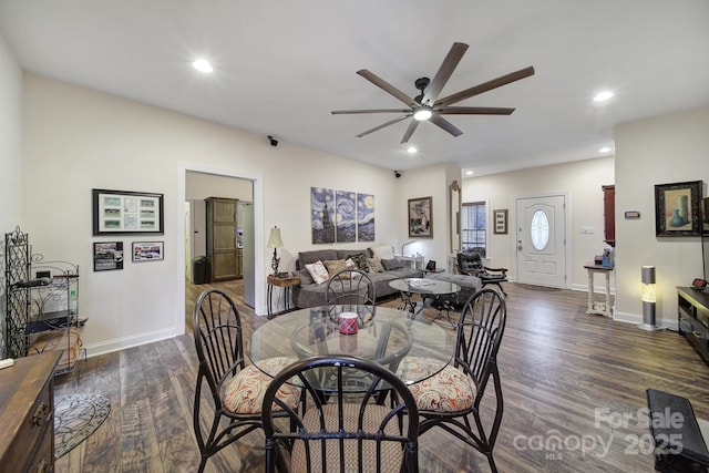 dining space with dark wood-type flooring and ceiling fan