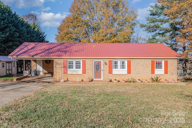 ranch-style home featuring a carport and a front yard