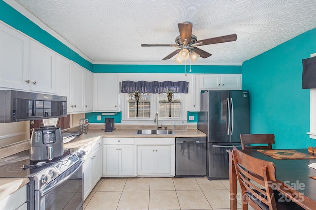 kitchen featuring sink, white cabinets, a textured ceiling, and appliances with stainless steel finishes