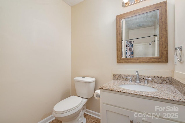 bathroom featuring tile patterned flooring, vanity, curtained shower, and toilet