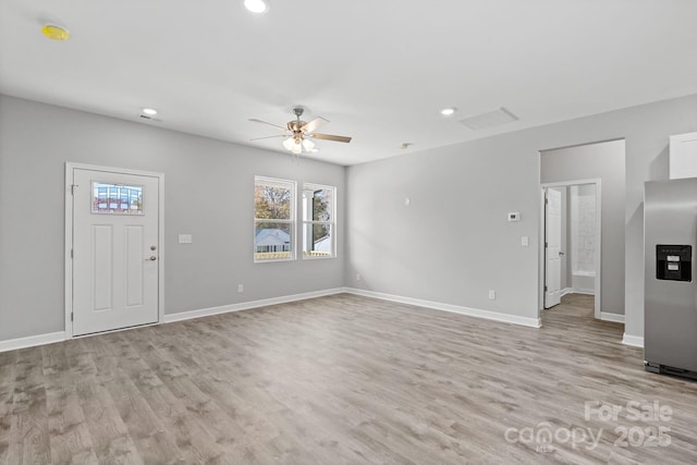 unfurnished living room featuring ceiling fan and light hardwood / wood-style floors