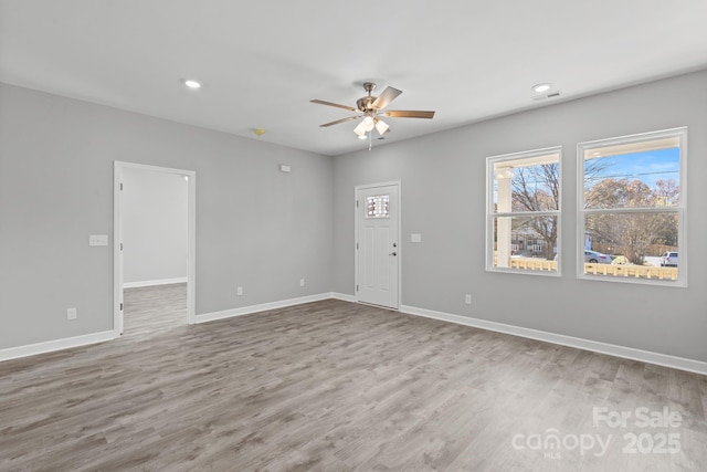 empty room featuring ceiling fan and wood-type flooring