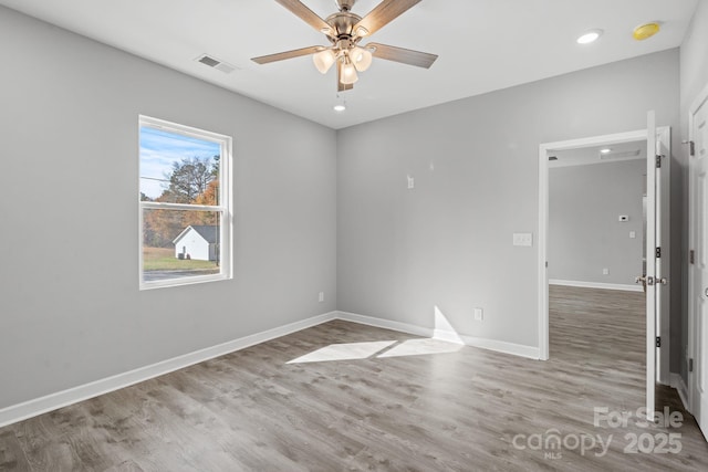 unfurnished room with ceiling fan and light wood-type flooring