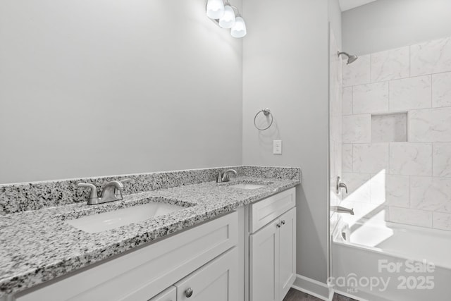 bathroom with vanity and tiled shower / bath