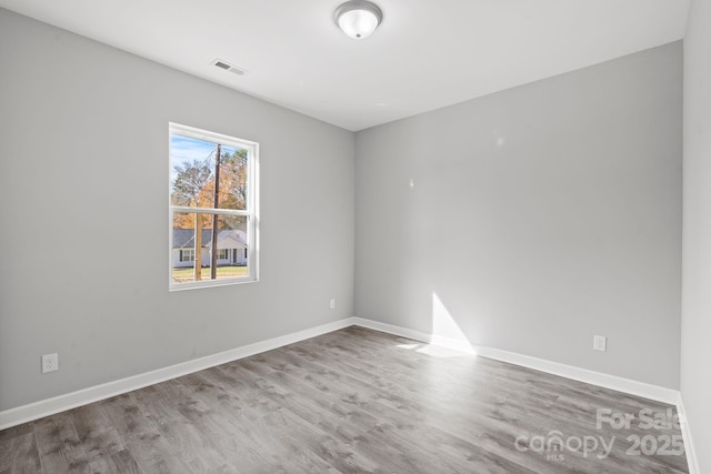 spare room with wood-type flooring